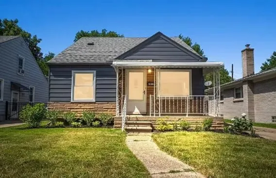 Blue-gray home exterior with stone accent skirting, freshly painted