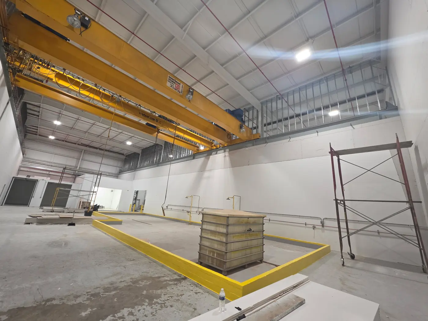 Yellow Macropoxy floor coating system applied near an overhead crane in an industrial facility